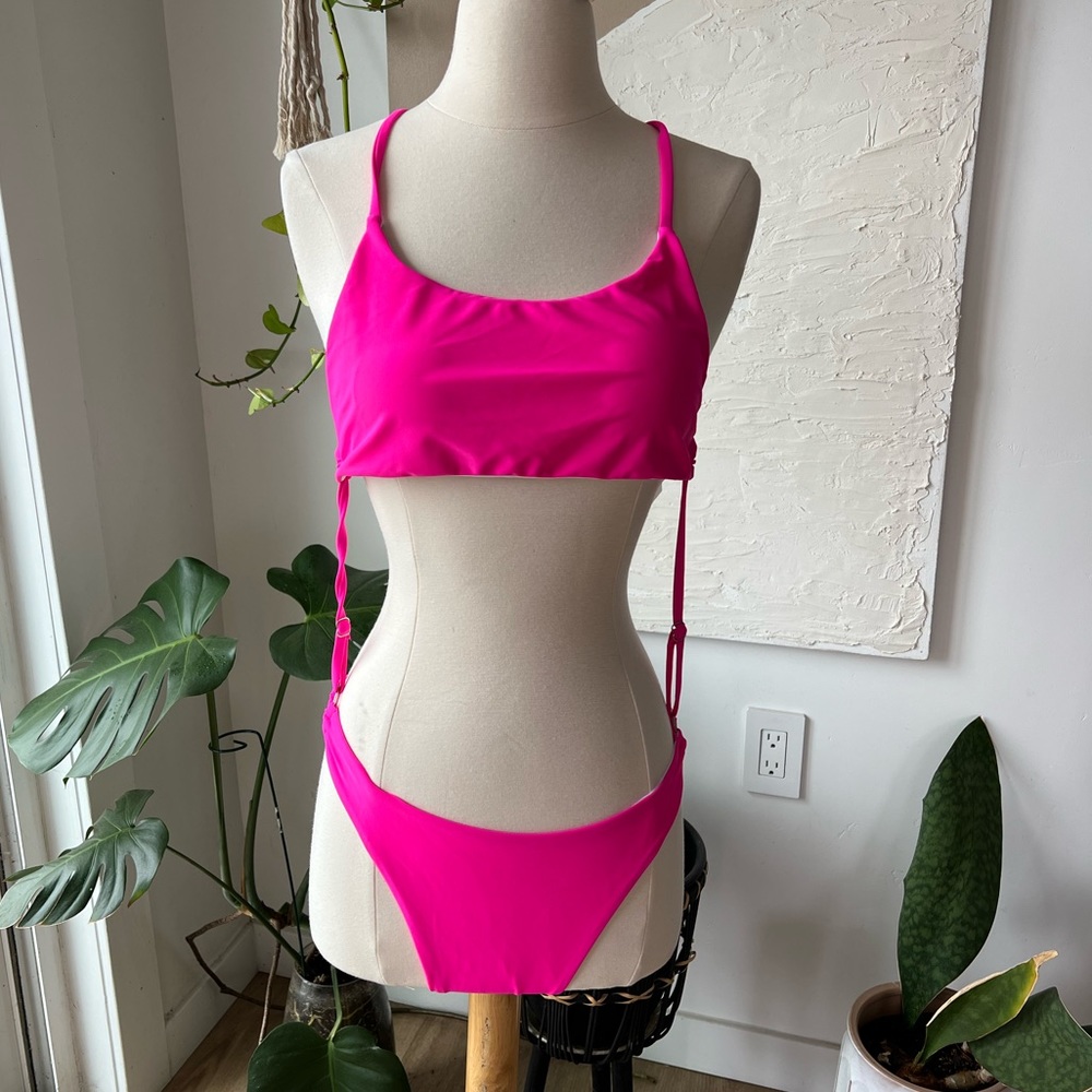 Pink Cut Out "One-Piece" swimsuit with adjustable sides. Size: M